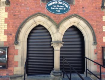 Aluroll Classic automatic roller shutters in Black fitted in a Welsh Methodist Chapel